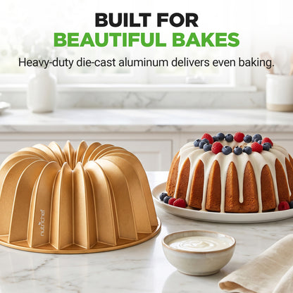 Bundt cake pan and baked cake with berries on a marble countertop, featuring text about heavy-duty die-cast aluminum.