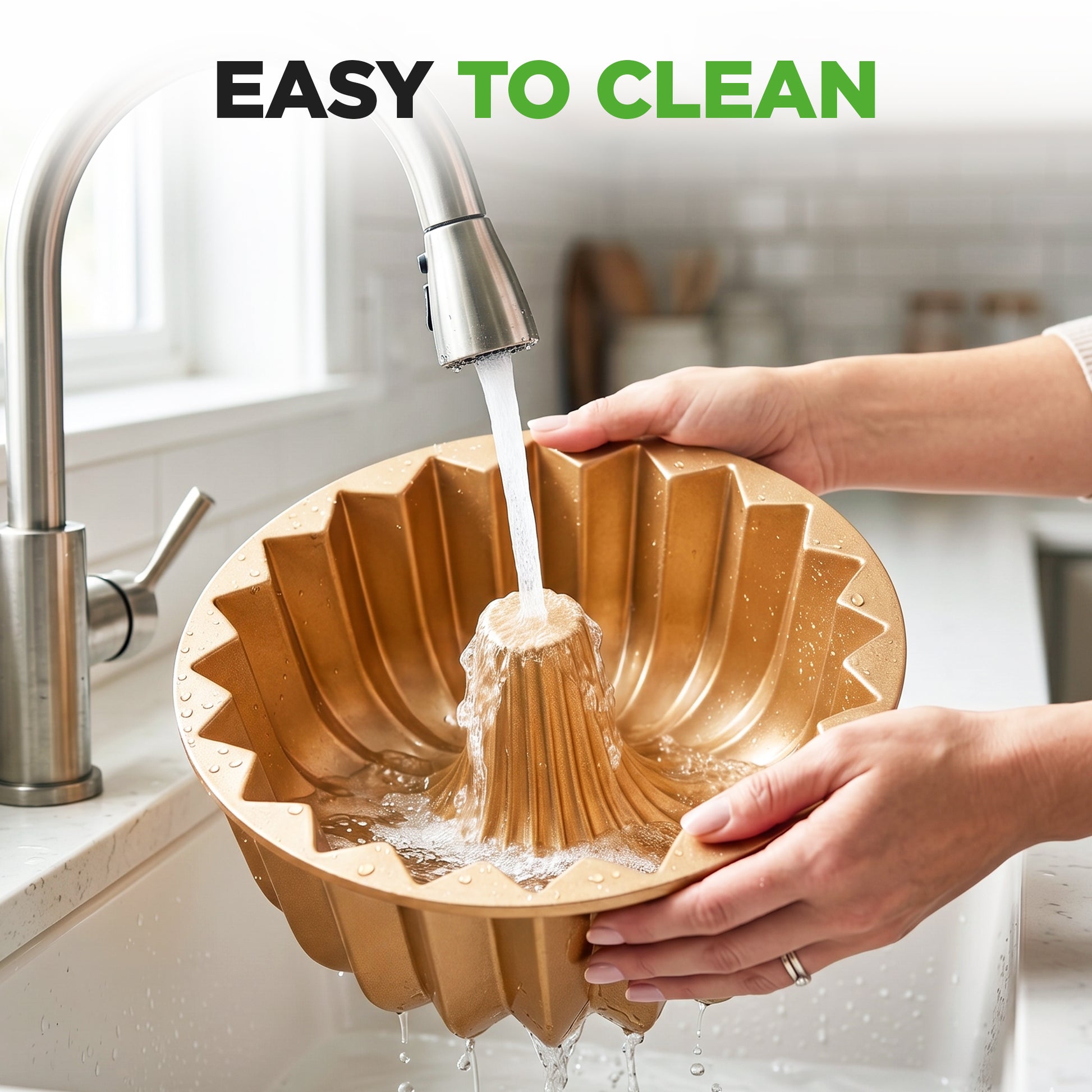 Person washing a gold-colored bundt cake pan under running water in a kitchen.