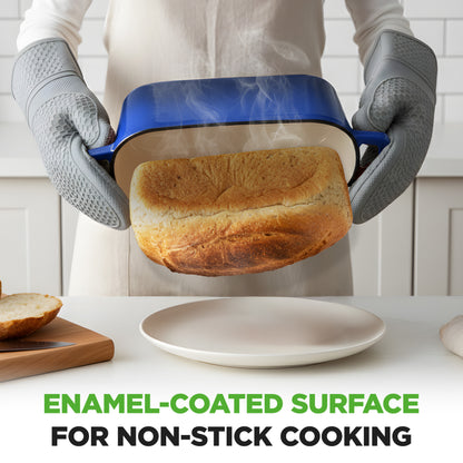 Person holding a blue pan with a loaf of bread, wearing gray gloves, in a kitchen setting.