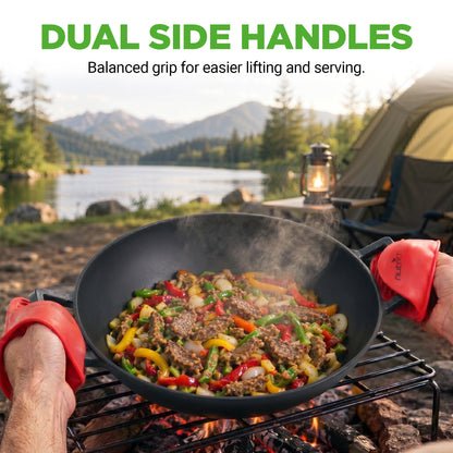 Person cooking outdoors with a wok over a campfire, featuring dual side handles.