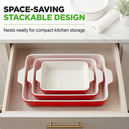 Three nested rectangular ceramic baking pans with white interiors and red exteriors are shown stacked inside an open kitchen drawer. Text at the top reads 'SPACE-SAVING STACKABLE DESIGN' with supporting copy about compact kitchen storage.