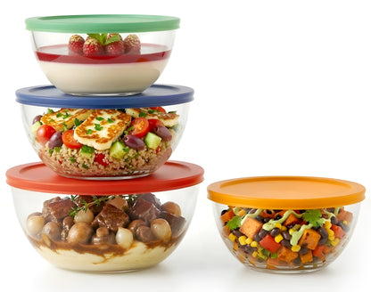 Set of glass food containers with colorful lids on a white background