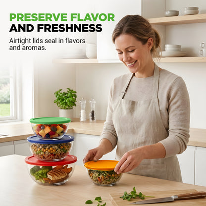 Woman in a kitchen with a stack of glass food containers on a counter.