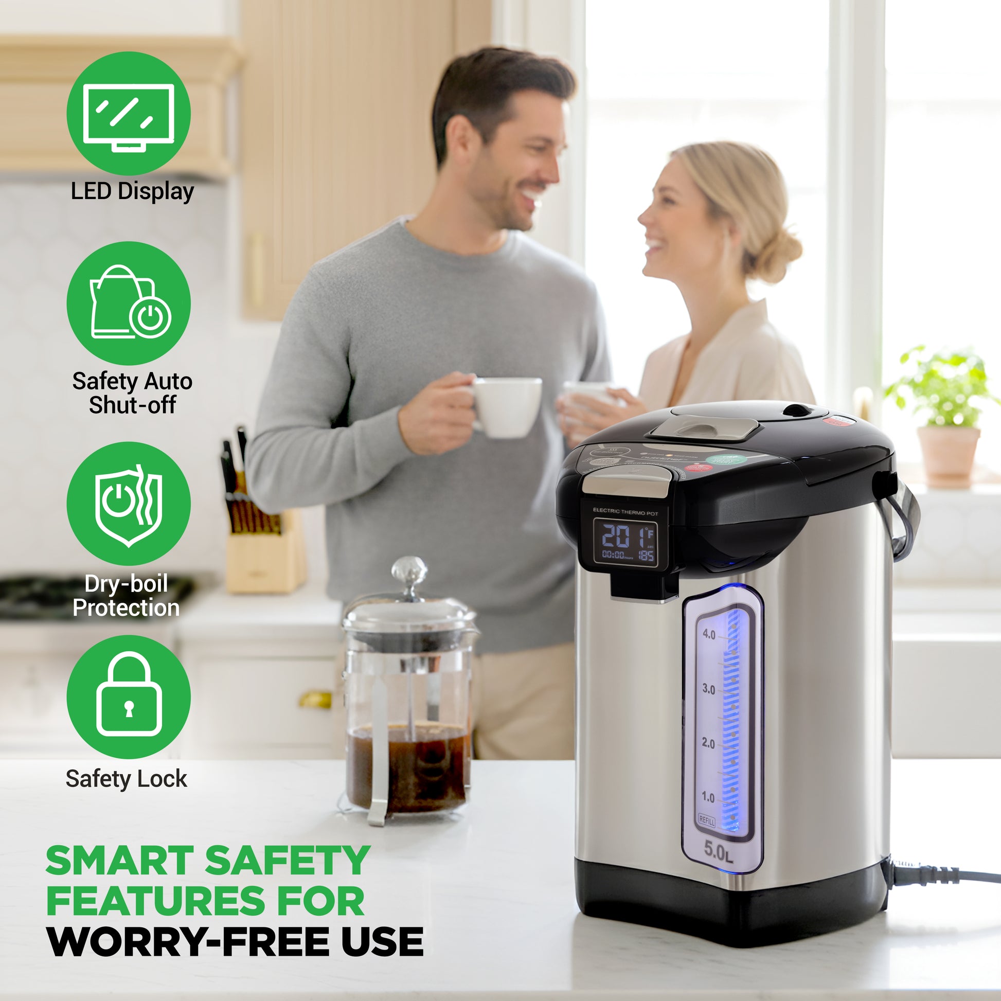 Electric kettle with safety features displayed on a kitchen counter, with a couple in the background.
