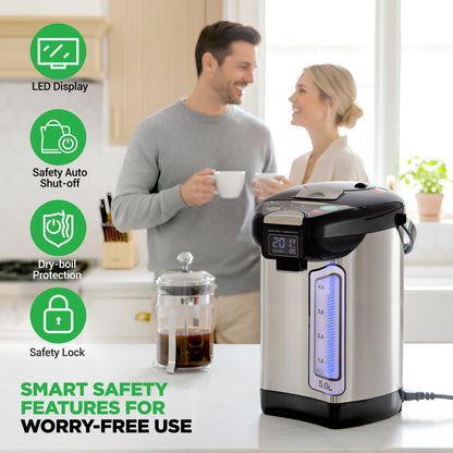 Electric kettle with safety features displayed on a kitchen counter, with a couple in the background.