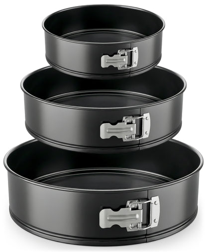 Set of three black springform pans with metal clamps on a white background