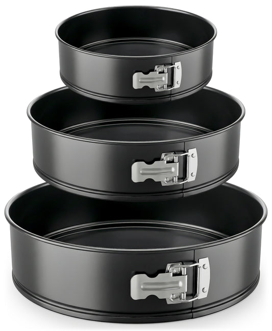 Set of three black springform pans with metal clamps on a white background
