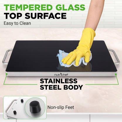 Person cleaning a black cooktop with text highlighting features like tempered glass top surface, stainless steel body, and non-slip feet.